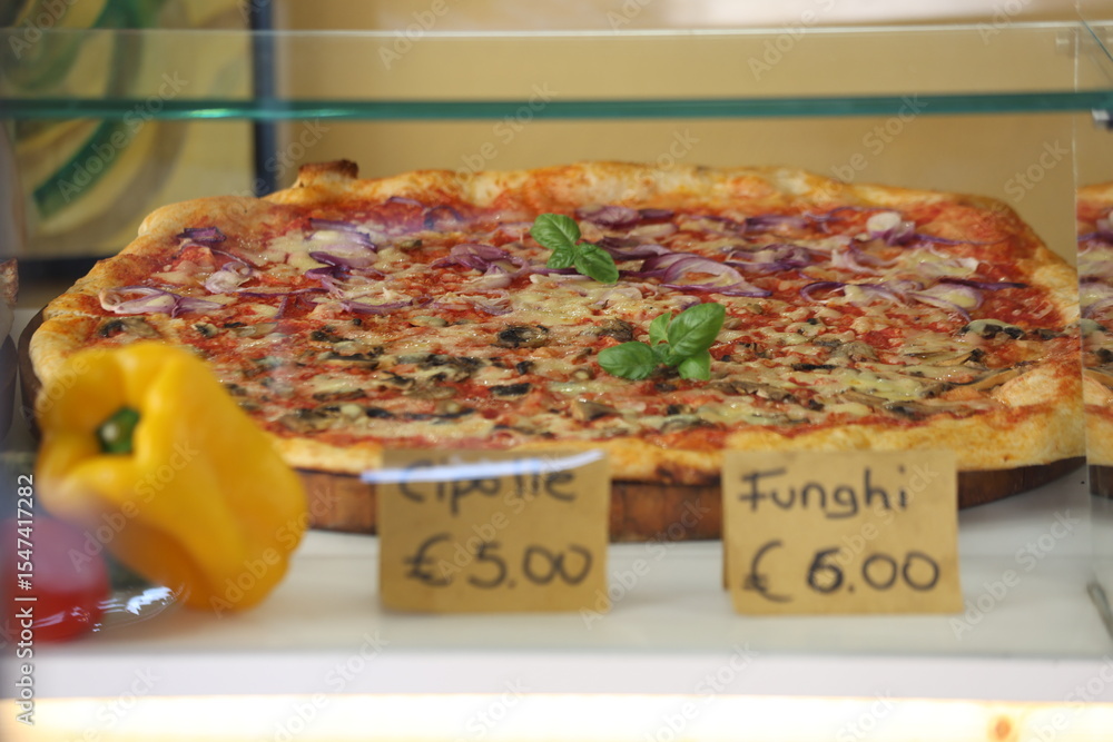 Fototapeta premium Fresh pizza ready for display with price tags in Euro, Italy