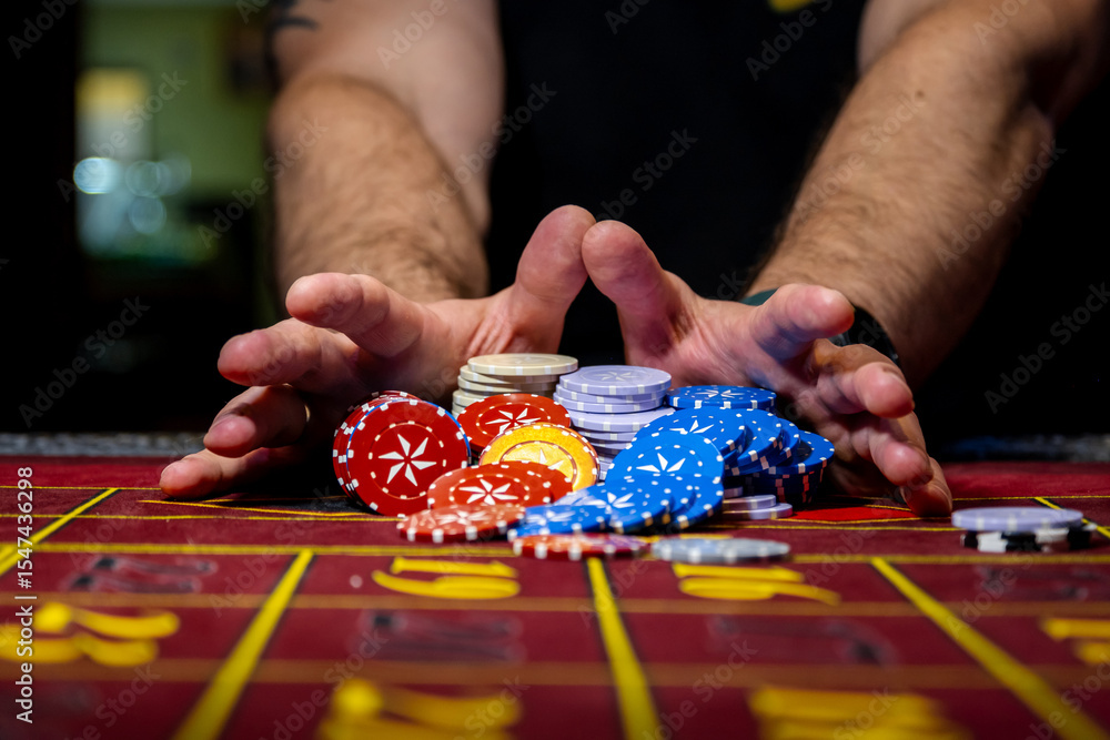 A player playing in a casino raises bets with chips. Gaming business. A player playing in a casino raises the bet with chips. Gaming business. A player playing in a casino raises bets with chips. Gaming business. A player playing in a casino raises the bet with chips. Gaming business.