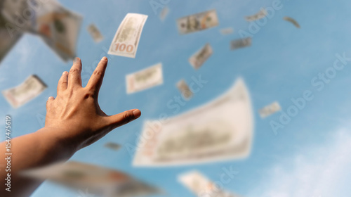 Картината върху платно Hands reaching for money floating in the air suggest the endless pursuit of wealth, ambition, and financial opportunity in a globalized world