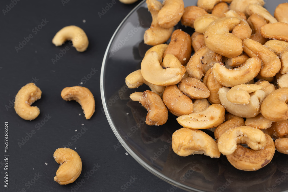 Naklejka premium Roasted or raw cashews. Delicious nuts cashew