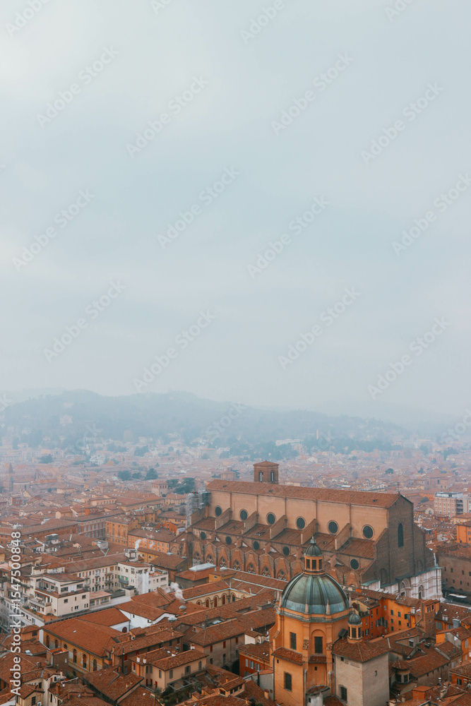 Obraz premium panorama of bologna italy with all red rooftops terracotta with foggy sky