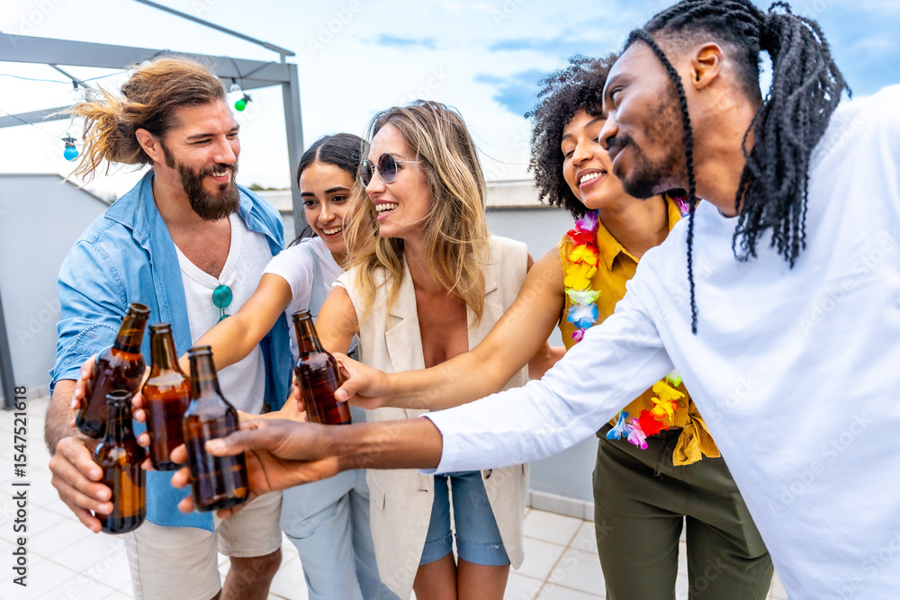 Obraz premium Friends toasting with beer bottles at rooftop party