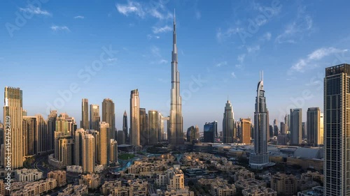 Dubai timelapse, sunrise over skyscrapers in Downtown Dubai, United Arab Emirates (UAE), modern buildings and cityscapes, innovation, business and finance concept, zooming out.