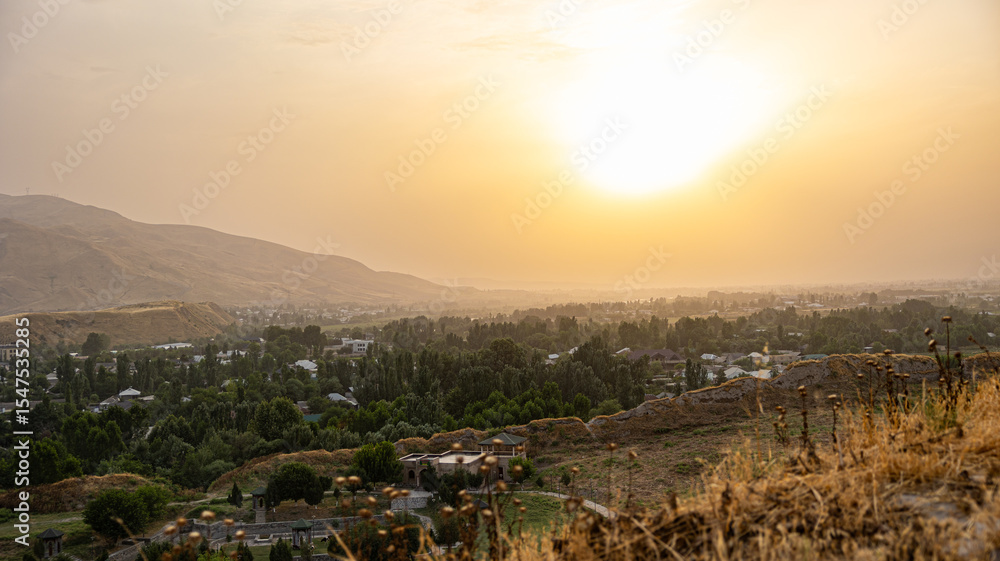 Fototapeta premium A stunning sunset casts vibrant colors over ancient architecture in a serene, beautiful landscape
