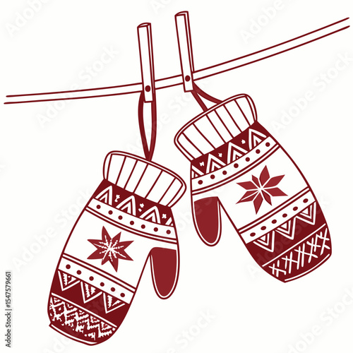 Two maroon mittens with snowflake pattern hanging on a clothesline.