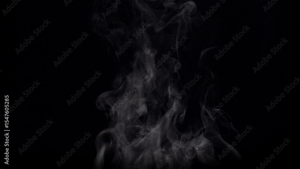 White natural rising steam from food or hot drink isolated on a black background.