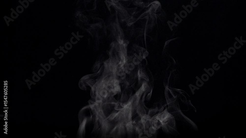 White natural rising steam from food or hot drink isolated on a black background.