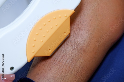 Close Up of Leg Hair Removal with a Device