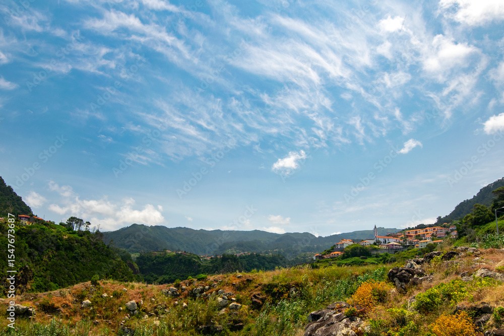 Obraz premium Small village in the mountains with blue sky in Madeira