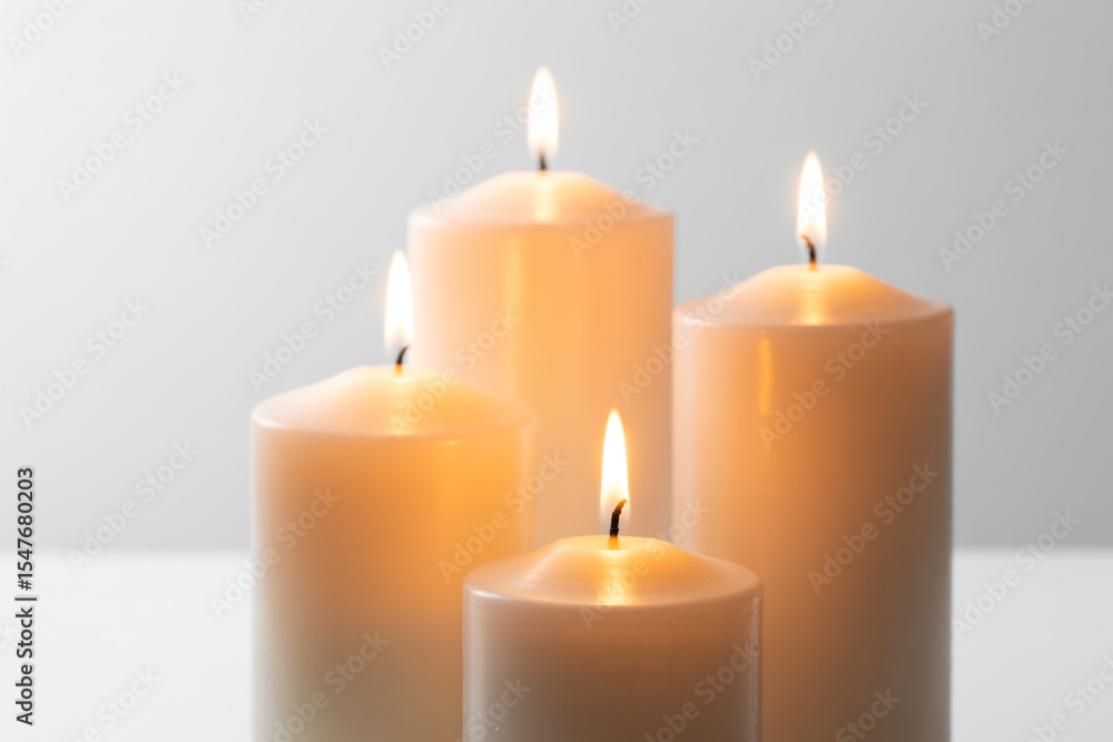 Burning candles with soft light on white background Burning candles with soft light on white background