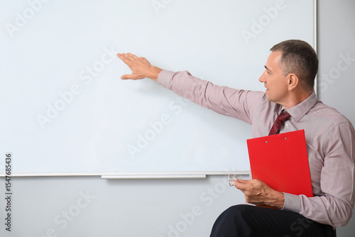 Male teacher with clipboard...