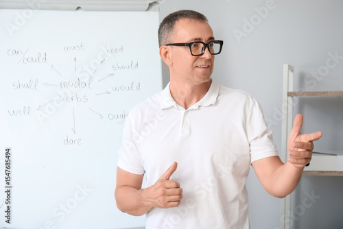 Male teacher conducting Eng...