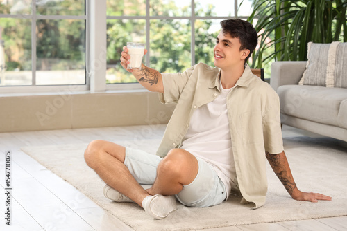 Young man with glass of mil...