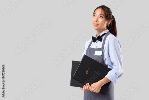 Young asian waitress holdin...