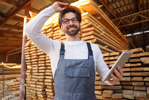 Male carpenter in hardhat w...