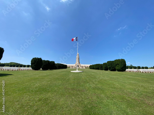 View of the Douaumont Ossuary from the military cemetery in Verdun, France, under a clear sky, commemorating World War I soldiers