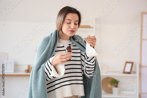Sick young woman with plaid...