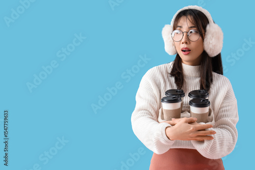 Young Asian woman with cups...
