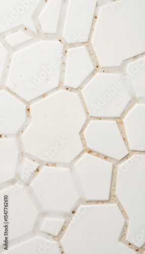 Hexagonal white tile pattern with subtle texture and colors  