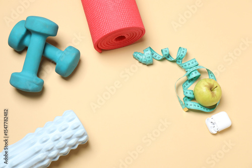 Set of sports equipment on beige background, top view
