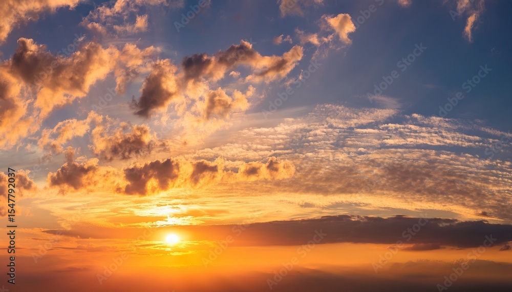 Fototapeta premium golden hour sky with soft clouds glowing warmly in sunlight creating peaceful and serene atmosphere in bright orange sky
