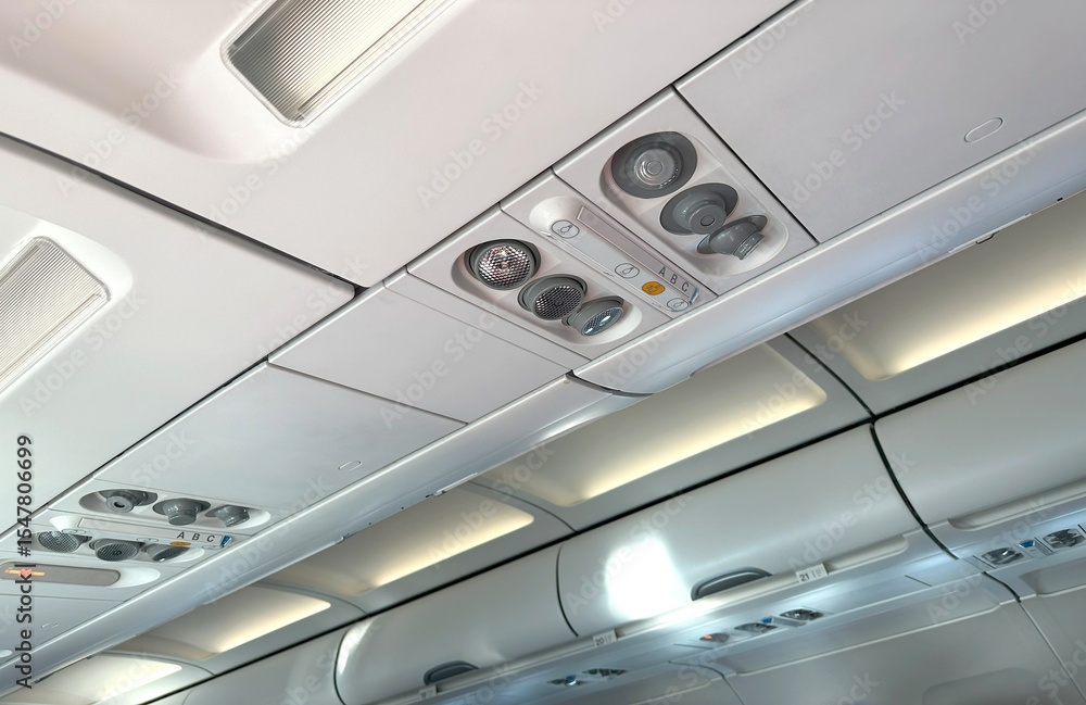 modern Airplane cabin interior, overhead panel with seatbelt and call buttons, reading light, call button, and air vent, flight experience, air journey, comfortable travel, airline industry modern Airplane cabin interior, overhead panel with seatbelt and call buttons, reading light, call button, and air vent, flight experience, air journey, comfortable travel, airline industry