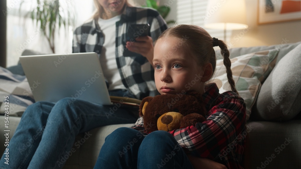 Caucasian family upset lonely kid girl suffering busy mother woman using laptop working from home ignoring child daughter holding Teddy Bear parenting ignore lack of attention childcare trouble stress Caucasian family upset lonely kid girl suffering busy mother woman using laptop working from home ignoring child daughter holding Teddy Bear parenting ignore lack of attention childcare trouble stress