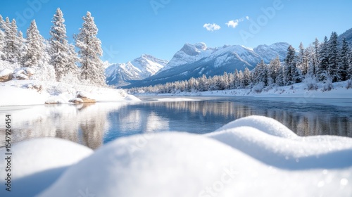 Wallpaper Mural A serene winter landscape featuring snow-covered trees and a tranquil river under clear blue skies. Torontodigital.ca