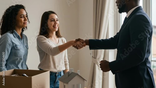 Happy people shaking hands in a new house real estate deal interior scene home purchase