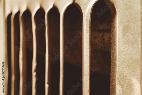 Obraz na plátně Shadows and light dance through archways in a quiet urban corner