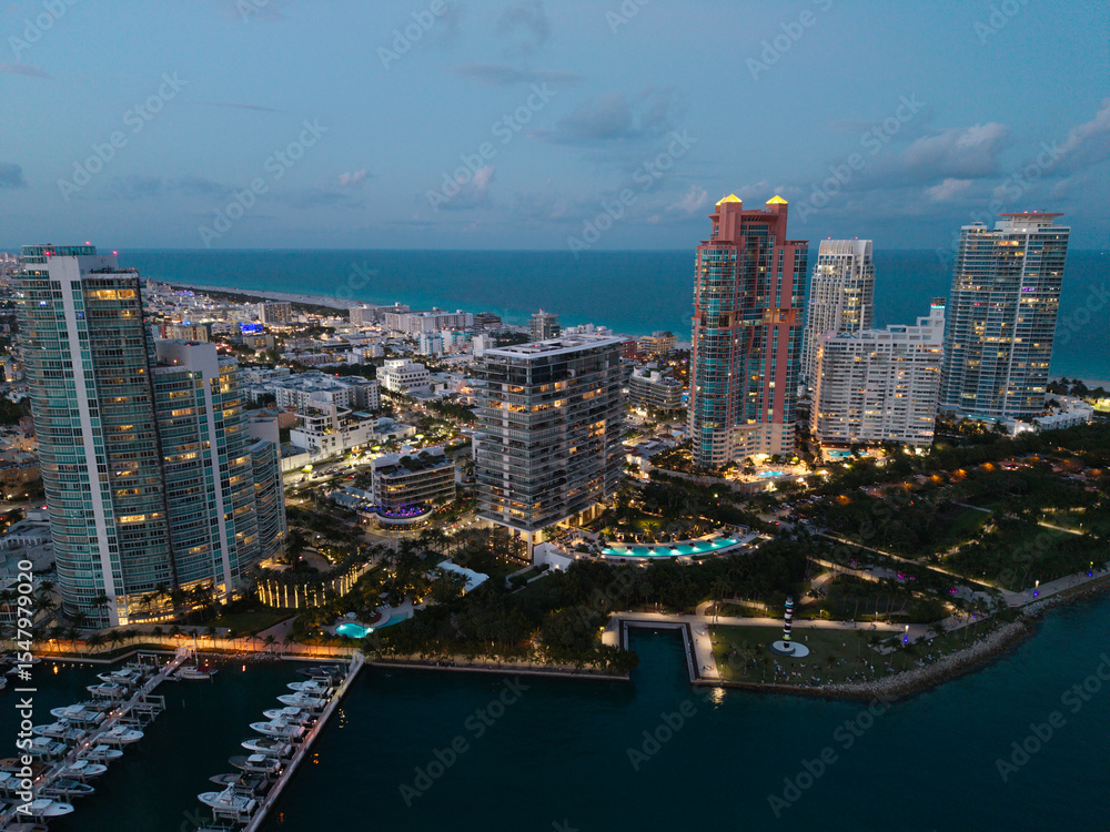 Naklejka premium Yacht docked at Miami marina. Aerial view of coastline in Miami. Miami skyline above harbor.