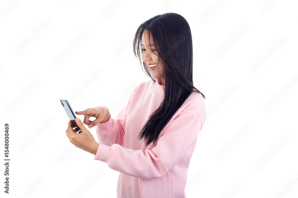Happy young Asian woman in pink sweatshirt using smartphone, smiling while browsing or chatting online. Isolated on white background with copy space Happy young Asian woman in pink sweatshirt using smartphone, smiling while browsing or chatting online. Isolated on white background with copy space