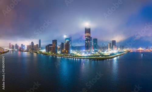 Wallpaper Mural Panoramic view of an illuminated modern coastal city skyline on a peninsula with mist and clouds at night in Zhuhai. Torontodigital.ca