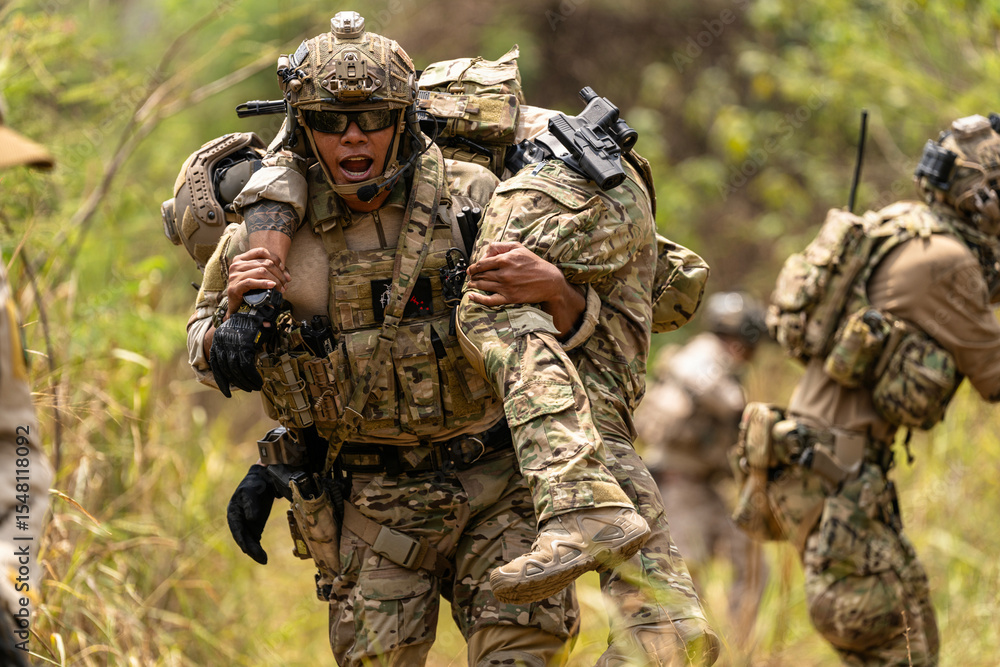 Fototapeta premium Soldier Carrying Injured Comrade During Tactical Combat Mission – Military Rescue Operation in Jungle, Armed Forces in Full Gear Providing Assistance Under Fire, Real Battlefield Scene