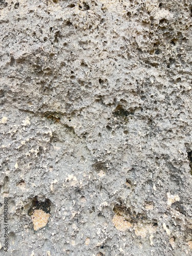 Old gray stone wall with rough abstract texture