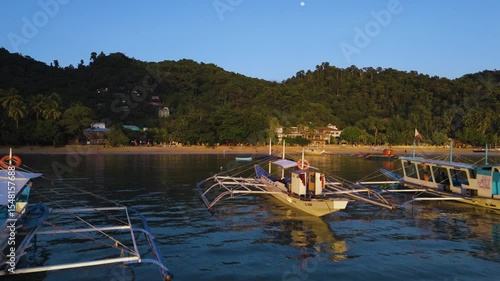 Wallpaper Mural Bangka boats resting in Clear Skies and Peaceful Blue Horizon Over Coastal Paradise of El Nido’s Corong Corong Beach Torontodigital.ca
