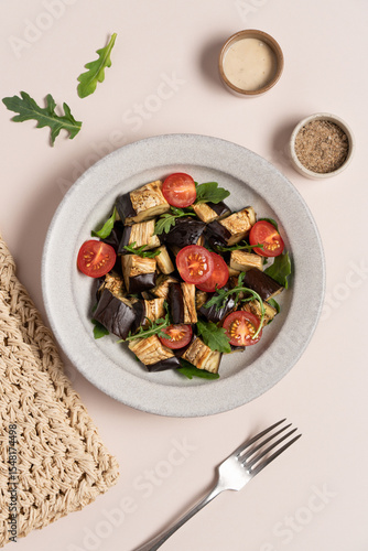 Wallpaper Mural Eggplants tomatoes arugula salad in gray bowl on light beige background. Vegetarian summer Mediterranean salad Torontodigital.ca