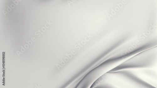 Two transition clips of black, white cloth gently falling onto a flat surface before being softly pulled away from the side of the frame to reveal a green-screen.