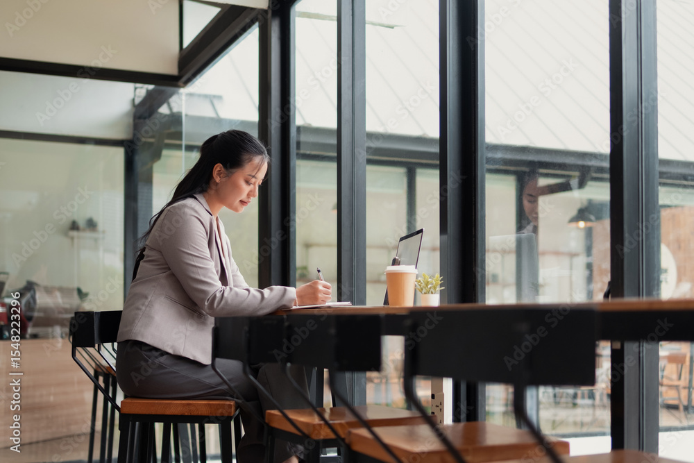 Young woman sitting and working in a cafe Young woman sitting and working in a cafe