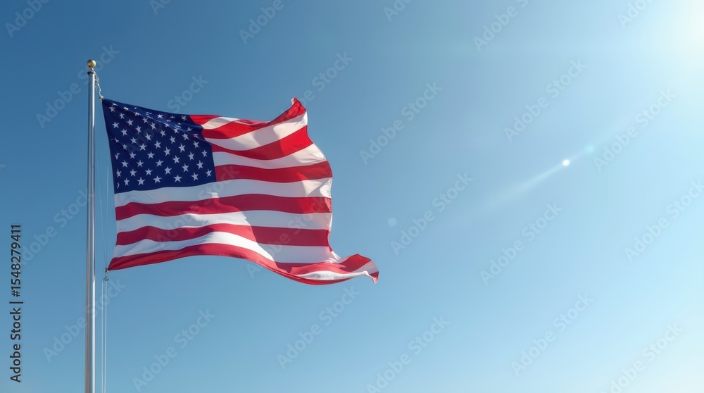 Obraz premium Waving American flag against a clear blue sky on Independence Day celebration in July