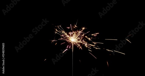 Lightening sparkler on the black background. Sparkler concept. Bengal lights are burning on a black background. Holiday party concept. New year party sparkler. Slow motion.