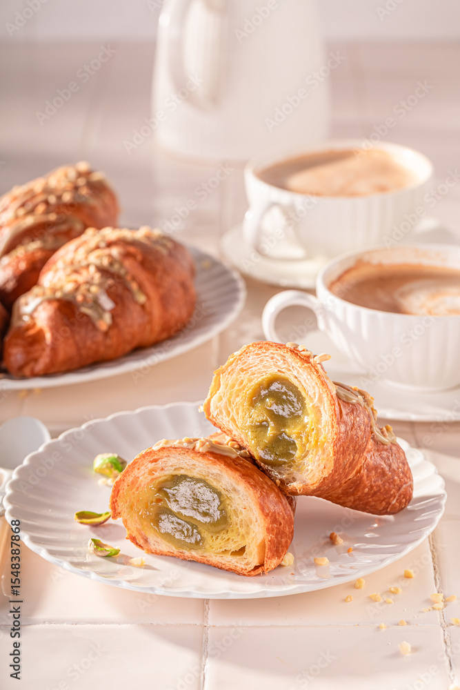 Tasty and traditionally pistachio croissants served with coffee. Tasty and traditionally pistachio croissants served with coffee.