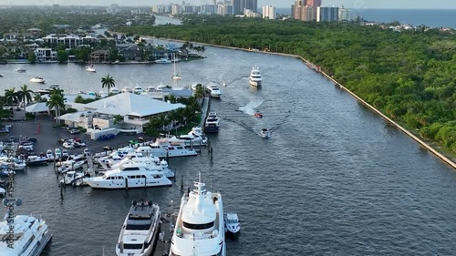4K drone footage of boats navigating through the canal near the 17th Street Causeway Bridge, also known as the E. Clay Shaw Jr. Bridge, in Fort Lauderdale, Florida. 