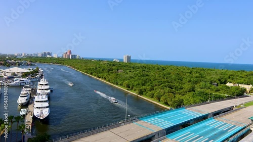 Time-lapse video of boats navigating through the canal near the 17th Street Causeway Bridge, also known as the E. Clay Shaw Jr. Bridge, in Fort Lauderdale, Florida. The scene captures the dynamic move