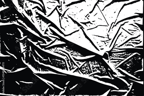black and white image of crumpled fabric with sharp lines and deep shadows creating texture.