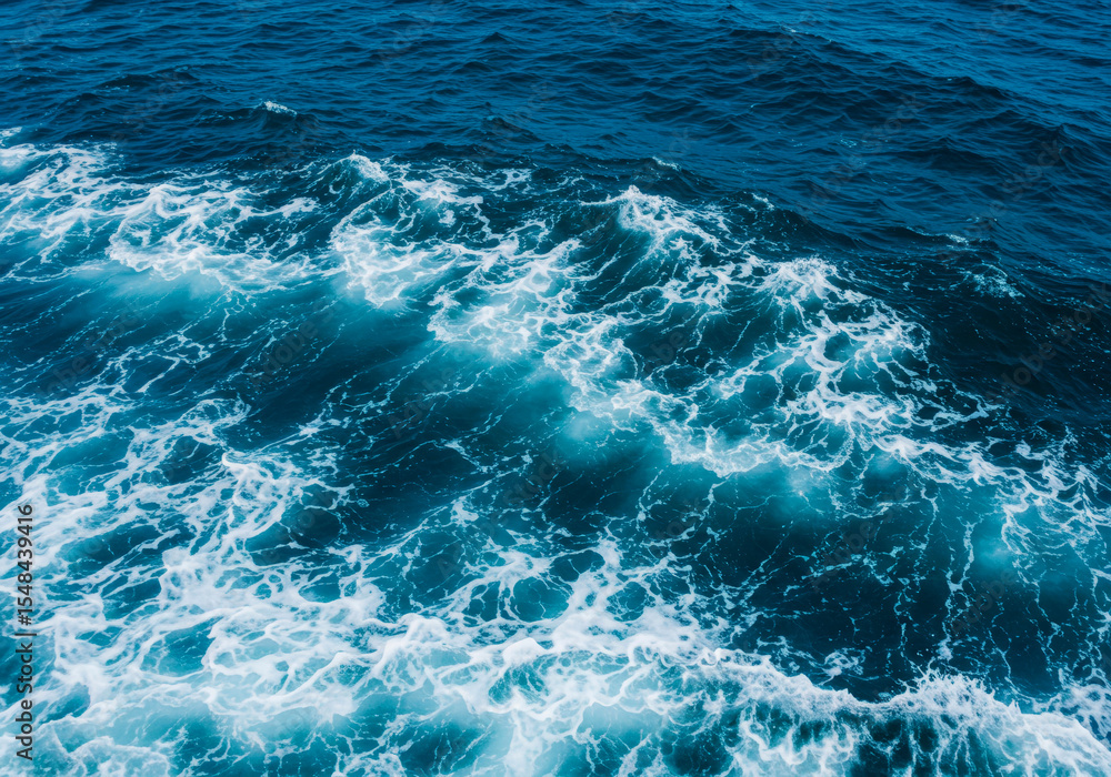 Fototapeta premium Abstract blue sea water with white foam for background