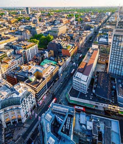 Obraz na plátne Aerial view of Oxford Street in London with bustling traffic, classic buildings, and red double-decker buses on a sunny, clear day