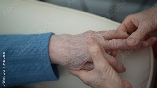 Photography A hand massage is being performed, focusing on relaxing the fingers and palm to alleviate tension