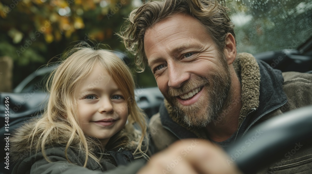 Fototapeta premium Caucasian father and daughter smiling outdoors in autumn with raindrops
