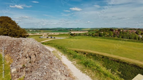 Concentric earthwork banks and weathered masonry remnants capturing the ancient fortifications, Old Sarum, Salisbury, Wiltshire, England, UK